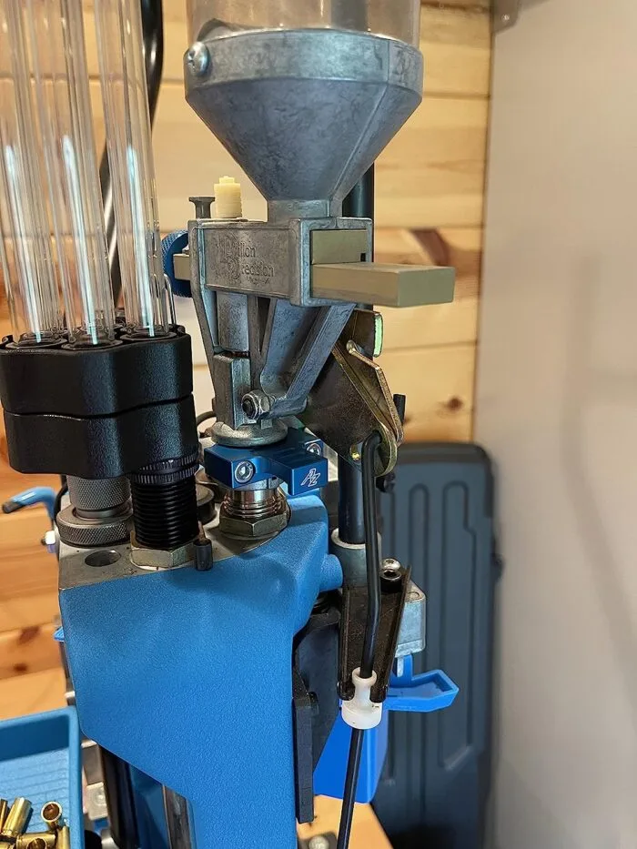 Close-up of a blue bullet reloading press.